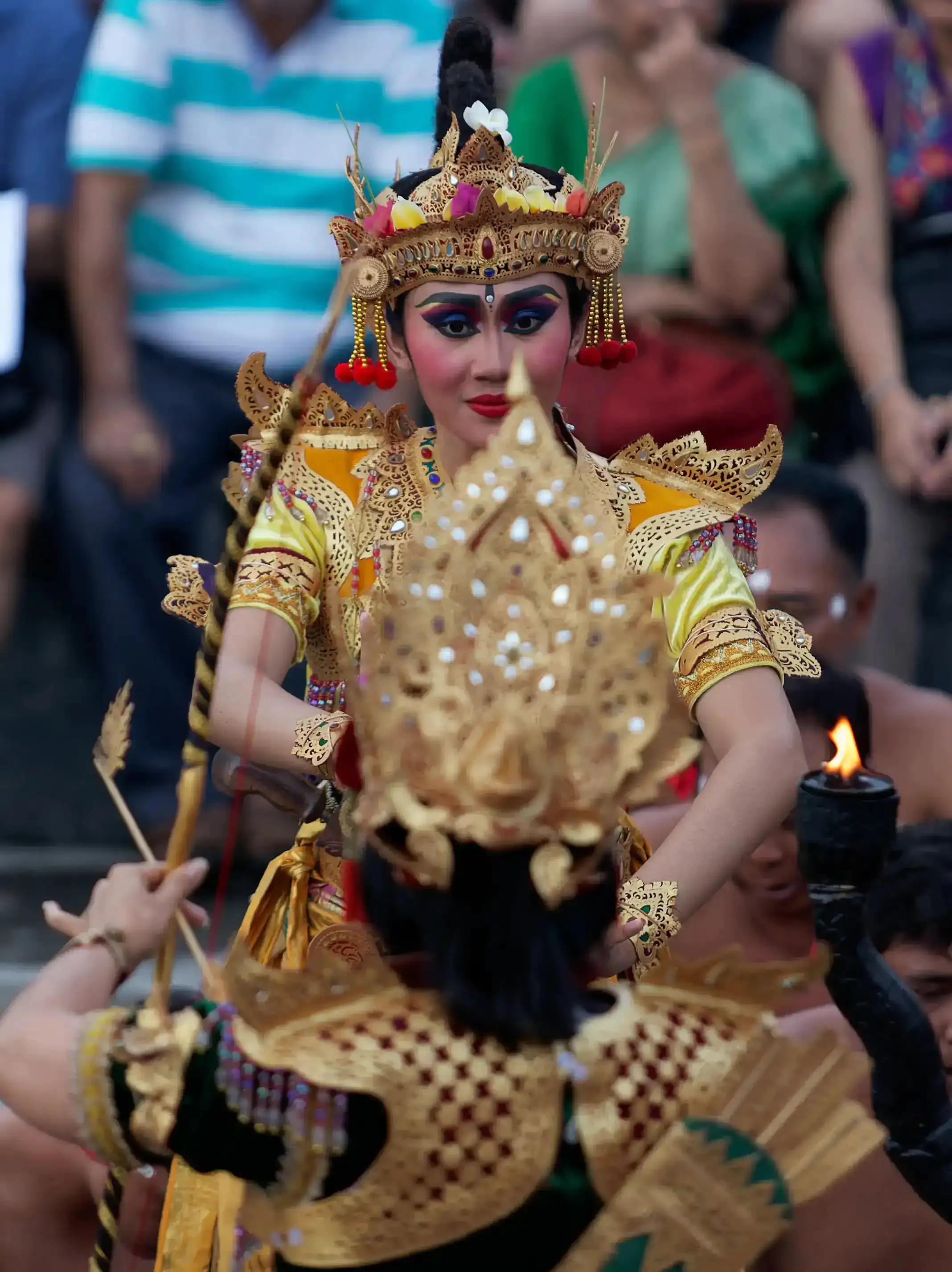 Traditional Balinese Kecak Dance performance at Uluwatu Temple during sunset